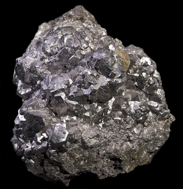 Skuttérudite (CoAs₃) : minéral de la famille « sulfures et sulfosels », système cubique, dureté 5,5 à 6 (Mohs), couleurs : blanc d'étain, gris argent